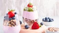 Superfoods layered pudding with granola, blueberry and strawberry in glasses. Yogurt with chia seeds, berries, kiwi and