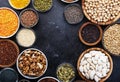 Superfoods, legumes, nuts, seeds and cereals selection in bowls on grey background. Superfood as chia, spirulina, beans, goji