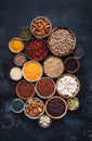 Superfoods, legumes, nuts, seeds and cereals selection in bowls on grey background. Superfood as chia, spirulina, beans, goji