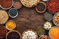 Superfoods, legumes, nuts, seeds and cereals set in bowls on wooden background. Superfood as chia, spirulina, beans, goji berries