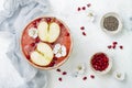 Superfoods smoothie bowl with chia seeds, pomegranate, sliced apples and honey. Overhead, flat lay. Rosh Hashana traditional food Royalty Free Stock Photo