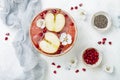 Superfoods smoothie bowl with chia seeds, pomegranate, sliced apples and honey. Overhead, flat lay. Rosh Hashana traditional food Royalty Free Stock Photo