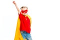 Supergirl wearing yellow cape and red mask for eyes gesturing by hand