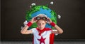 Superhero boy in front of planet earth world with blackboard background