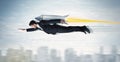 Superhero business man flying with jet pack rocket above the cit Royalty Free Stock Photo