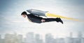 Superhero business man flying with jet pack rocket above the cit Royalty Free Stock Photo