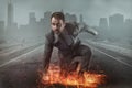 Superhero businessman concept with fire and city background Royalty Free Stock Photo