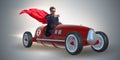 The superhero businessman driving vintage roadster Royalty Free Stock Photo