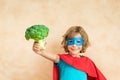 Superhero child eating superfood