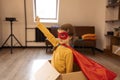 Superhero child. Super hero kid, playing at home in box