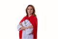 Superhero and leader concept- portrait of cheerful female doctor with red hero cape standing with folded arms, isolated on white Royalty Free Stock Photo