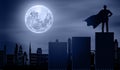 Superhero Man Stands Looking To The city buildings At Night with Moon light. Businessman Silhouette Hero on Graph Stairs in Front