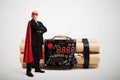 Superhero in red cloak and mask standing near big bomb Royalty Free Stock Photo