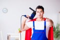 The superhero repairman with tools in repair concept Royalty Free Stock Photo