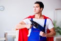 The superhero repairman with tools in repair concept Royalty Free Stock Photo