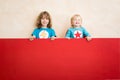 Superheroes children holding red banner blank