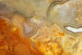 Supermacro image of translucent light agate in orange siliceous rock