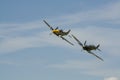 A Supermarine Spitfire and North American P-51 Mustang flying in tandem
