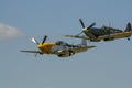 A Supermarine Spitfire and North American P-51 Mustang flying in tandem