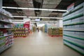 Supermarket blurred background with colorful shelves and unrecognizable customers