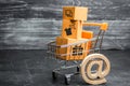 Supermarket cart with boxes, merchandise: the concept of buying and selling goods and services, internet commerce, online shopping