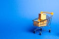 Supermarket cart with boxes, merchandise. the concept of buying and selling goods and services, internet commerce, online shopping Royalty Free Stock Photo