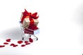 A supermarket cart filled to the brim with red confetti hearts and a gift box wrapped in kraft paper and tied with a red ribbon on Royalty Free Stock Photo