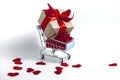 A supermarket cart filled to the brim with red confetti hearts and a gift box wrapped in kraft paper and tied with a red ribbon on Royalty Free Stock Photo