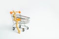 A supermarket cart and a wooden arrow down on a white background. The concept of the fall of prasada and the deterioration of cons Royalty Free Stock Photo