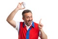 Supermarket employee holding light bulb above head