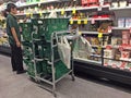 Supermarket employee stacking items into a cart for online pickup/delivery options