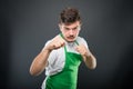 Supermarket employer posing showing fists like fighting