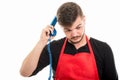 Supermarket employer scratching with blue phone receiver like th Royalty Free Stock Photo