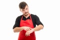 Supermarket employer showing wrist watch like being late