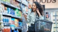 Supermarket, grocery shopping and surprise of a black woman on a phone call at a retail store. Wow, happy and omg facial Royalty Free Stock Photo