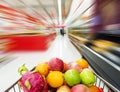 Supermarket interior, filled with fruit of shopping cart. Royalty Free Stock Photo