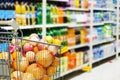 Supermarket interior, filled with fruit of shopping cart. Royalty Free Stock Photo