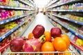 Supermarket interior, filled with fruit of shopping cart. Royalty Free Stock Photo