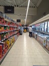 Supermarket interior with shelves full of various products, people at shopping. Bucharest, Romania, 2021 Royalty Free Stock Photo