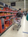 Supermarket interior with shelves full of various products, people at shopping. Bucharest, Romania, 2021 Royalty Free Stock Photo