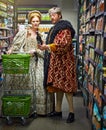 Supermarket, king and queen with wine, choice and costume with increase prices and inflation. Royal couple, man and Royalty Free Stock Photo