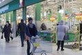 A supermarket, a man with an empty cart, worker, editorial