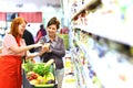 Supermarket salesperson advises a customer - fresh food sales