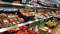 Supermarket shelves with plastic packed vegetables Royalty Free Stock Photo