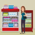 Supermarket shelvings with woman buying