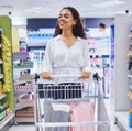 Supermarket, store and shopping customer with a trolley cart for wellness, healthy product and grocery sales goods