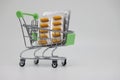 A supermarket trolley full of blister pills, a lot of pills in a wheelbarrow. Concept: home delivery of medicines.Empty