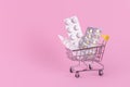 A supermarket trolley full of blister pills, a lot of pills in a wheelbarrow, nasal spray. Concept: home delivery of medicines. Royalty Free Stock Photo