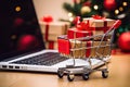 Supermarket trolleys full of gift boxes sot on laptop on table, gift shopping concept