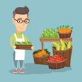 Supermarket worker with a box full of apples. Royalty Free Stock Photo